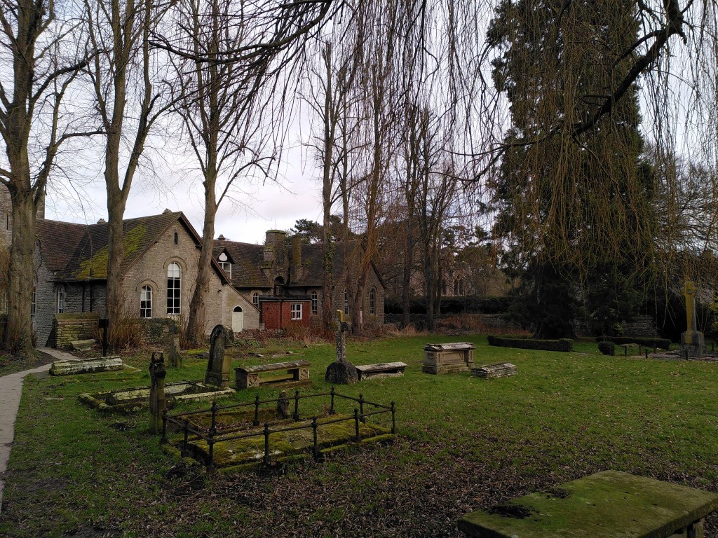 The churchyard of Holy Trinity Church, Much Wenlock, with the Priory ruins in the background.