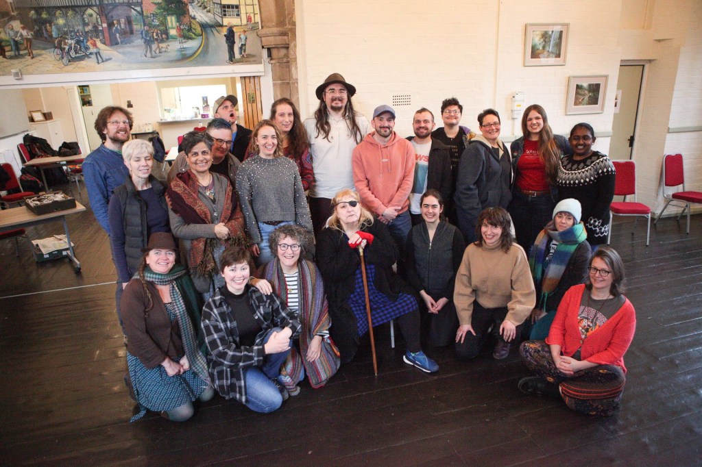 A gathering of storytellers and poets pose for the camera.